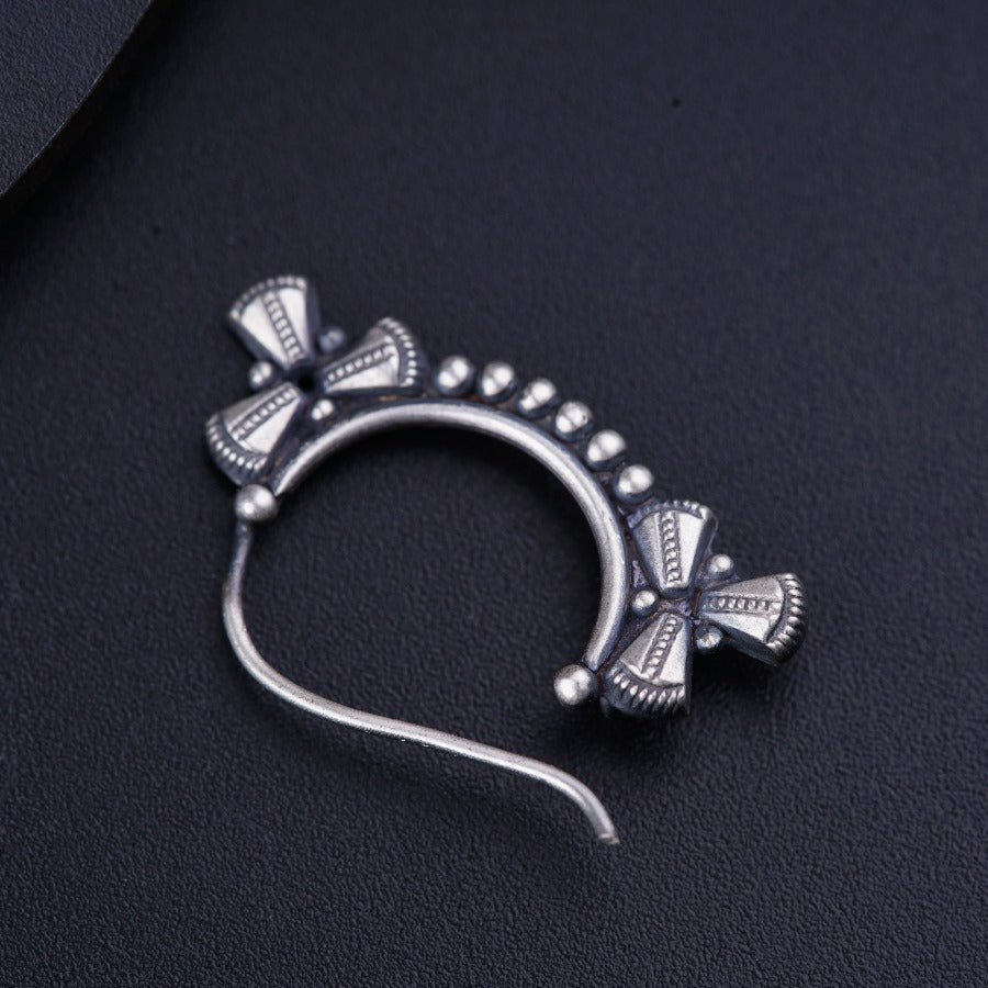 a close up of a metal object on a black surface