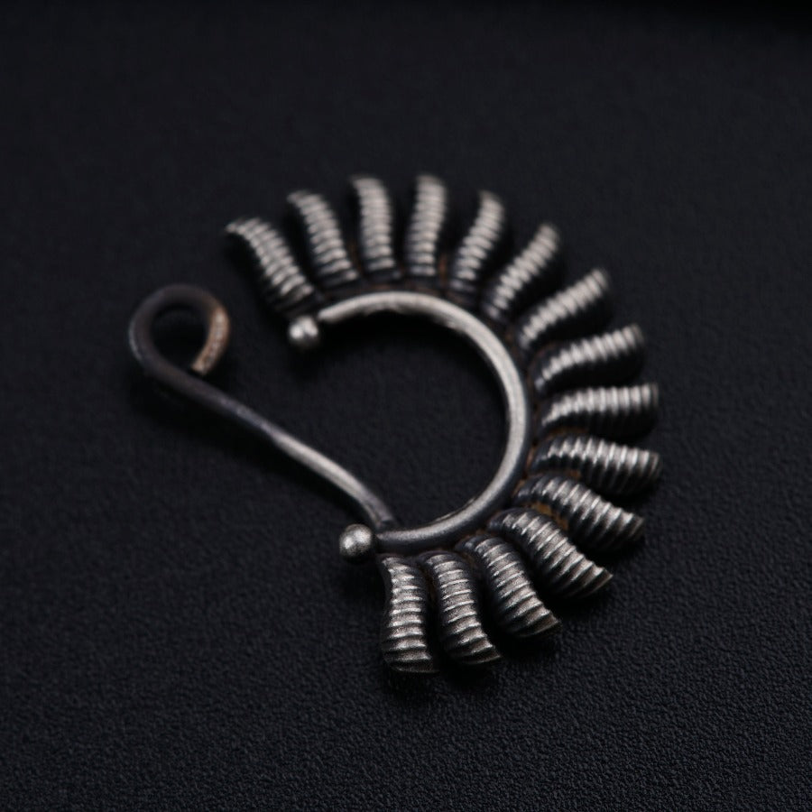 a close up of a metal object on a black surface