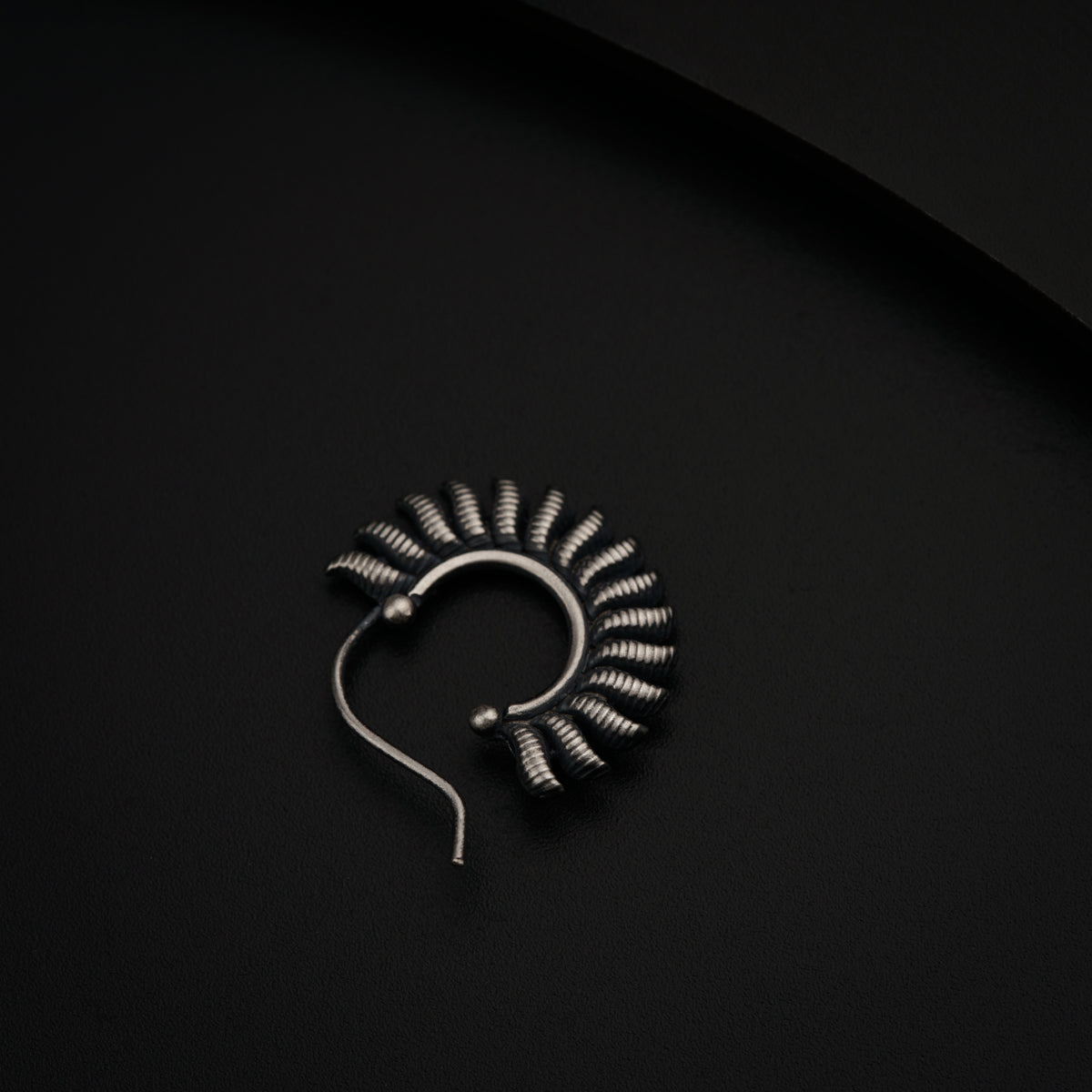 a metal object on a black surface