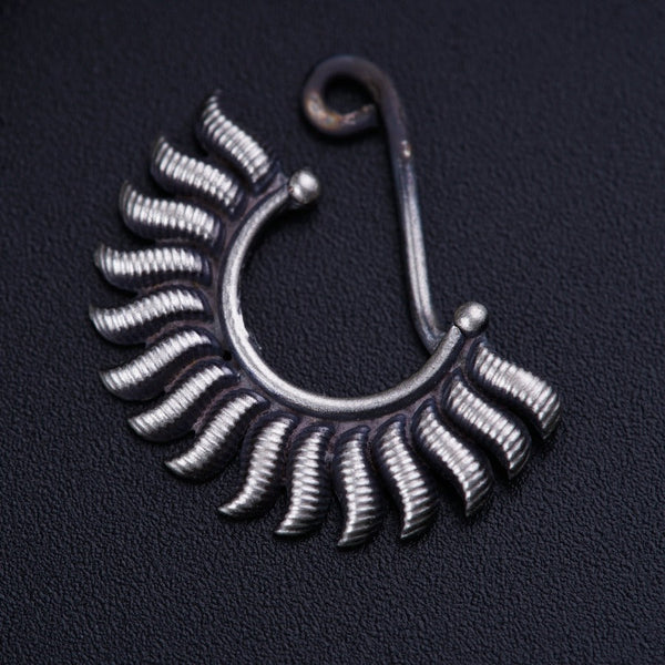 a close up of a metal object on a black surface