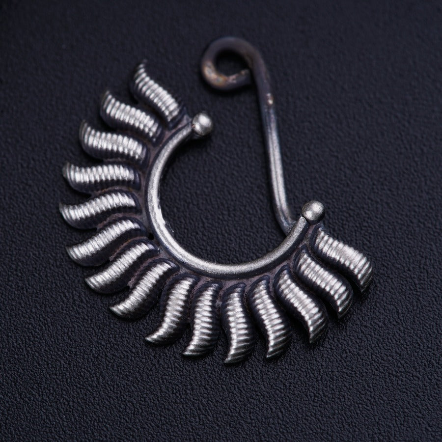 a close up of a metal object on a black surface