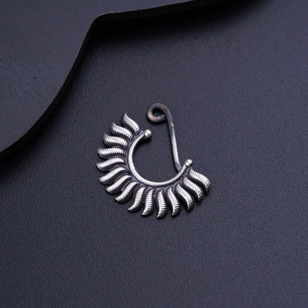 a close up of a pair of earrings on a black surface