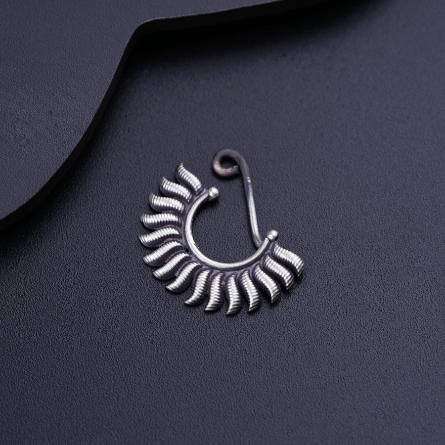 a close up of a pair of earrings on a black surface
