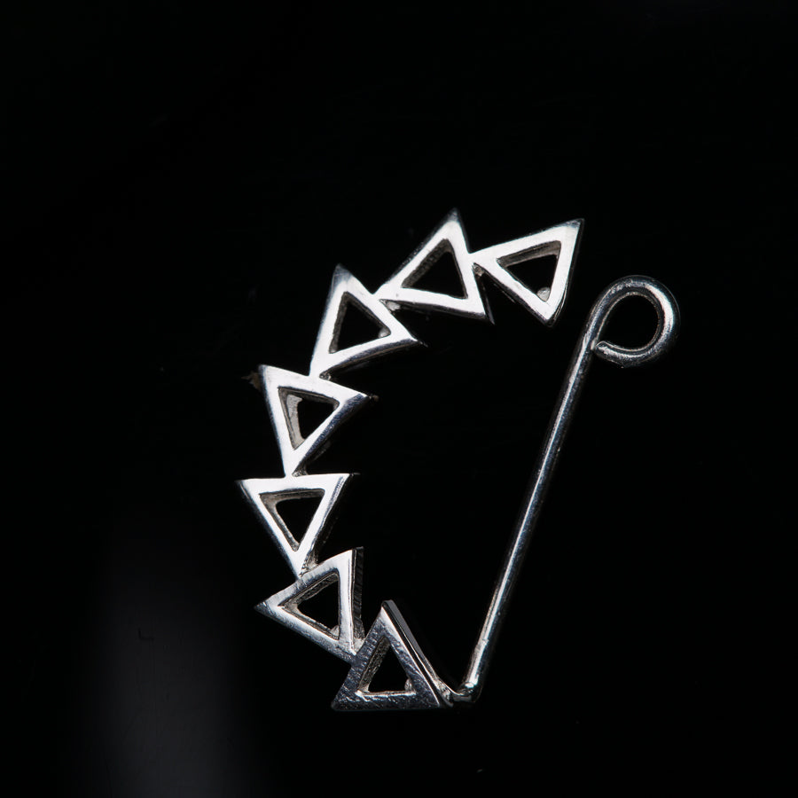 a close up of a metal object on a black background