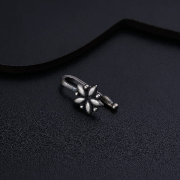 a pair of silver rings sitting on top of a black surface