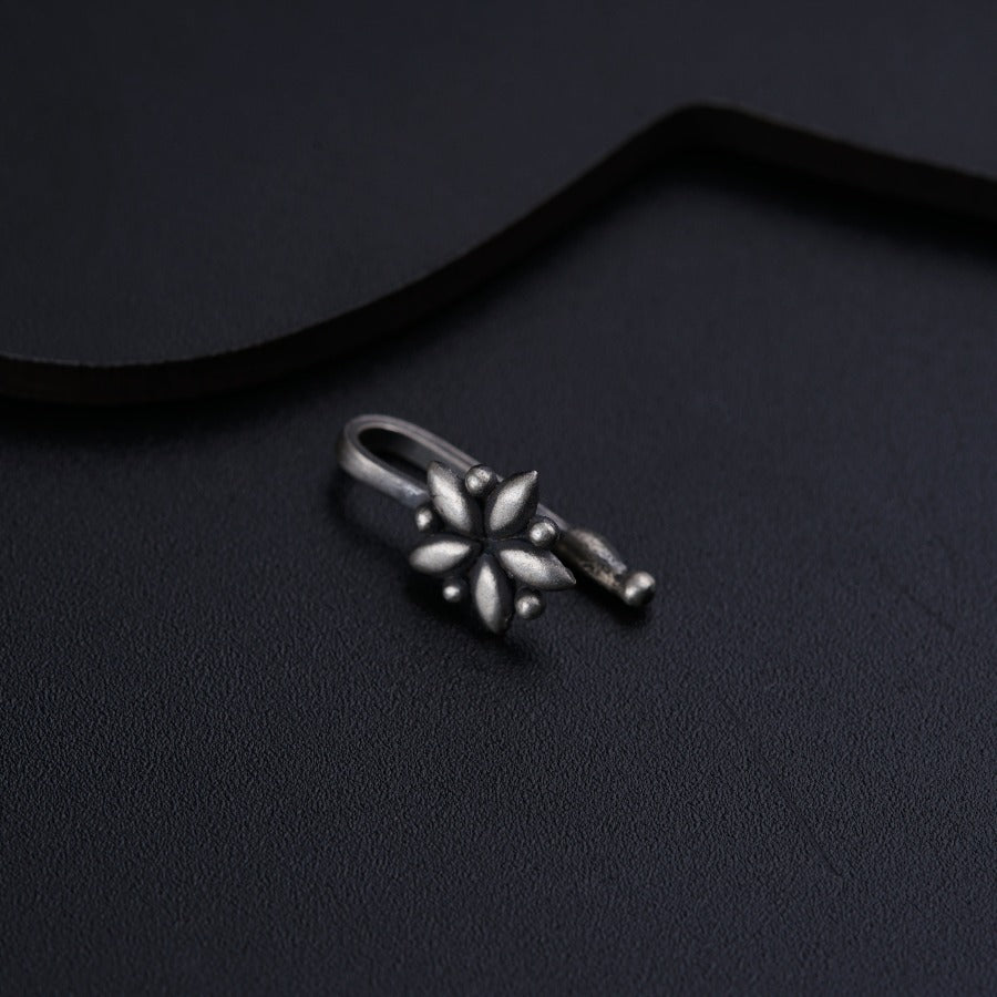 a pair of silver rings sitting on top of a black surface