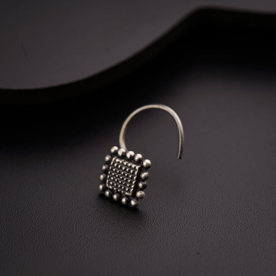 a pair of earrings sitting on top of a table