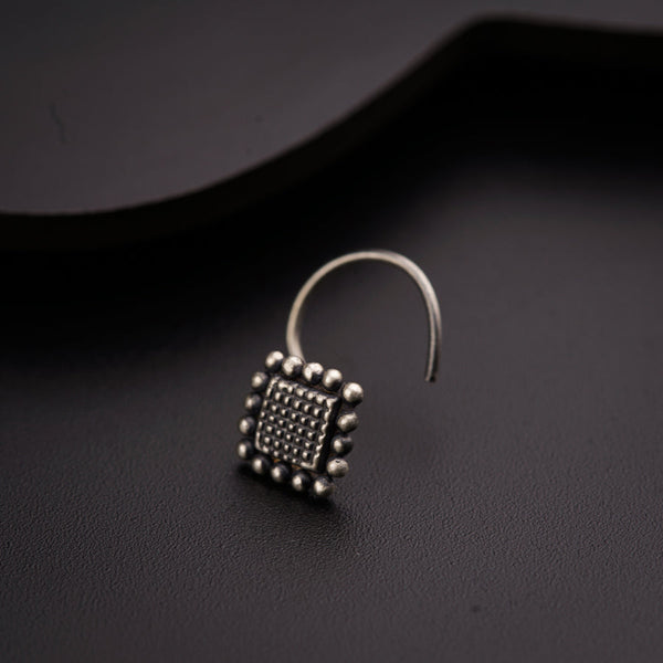 a pair of earrings sitting on top of a table
