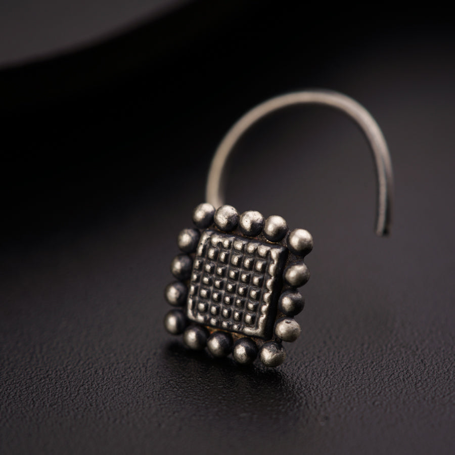 a close up of a metal object on a black surface