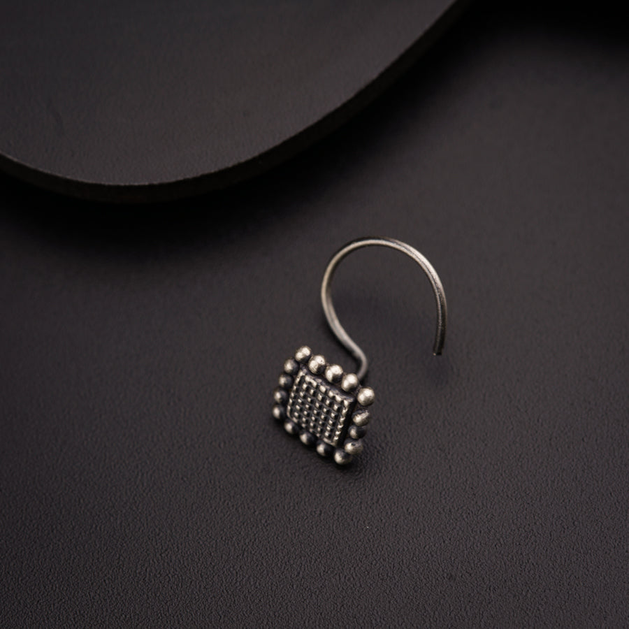 a pair of earrings sitting on top of a table