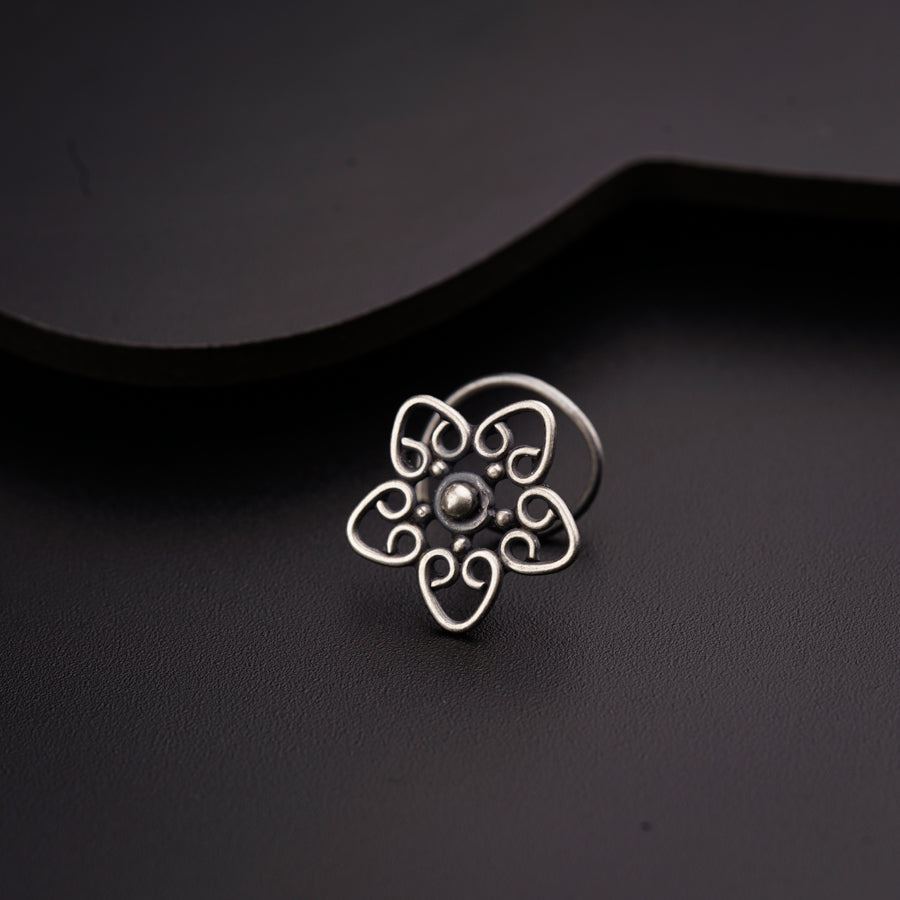 a close up of a ring on a black surface