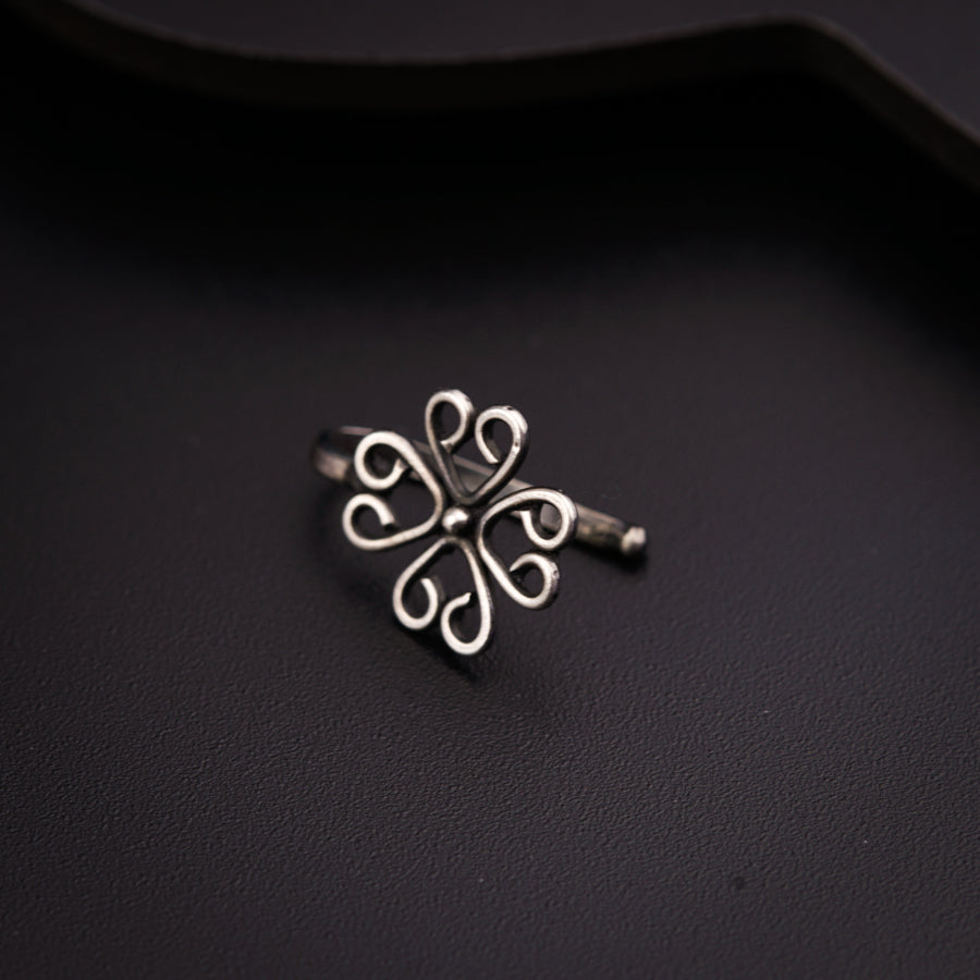 a close up of a metal object on a black surface