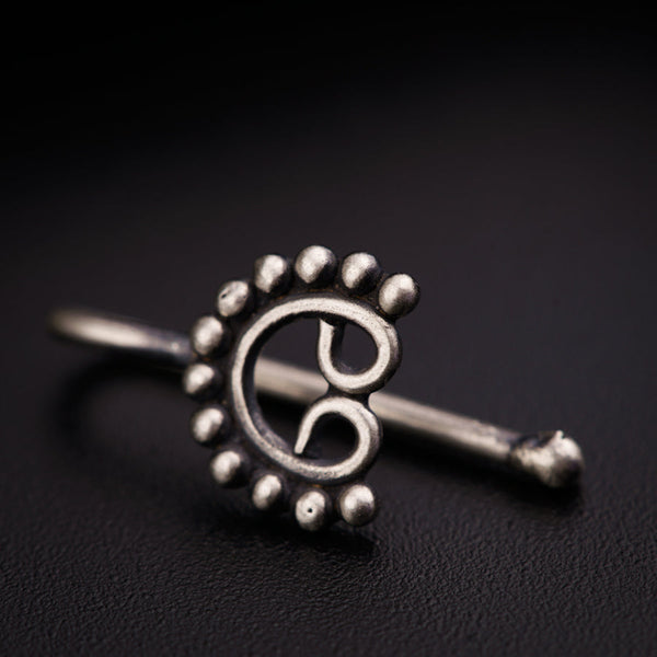 a close up of a metal object on a black surface