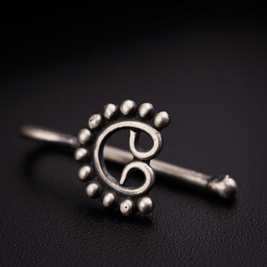 a close up of a metal object on a black surface