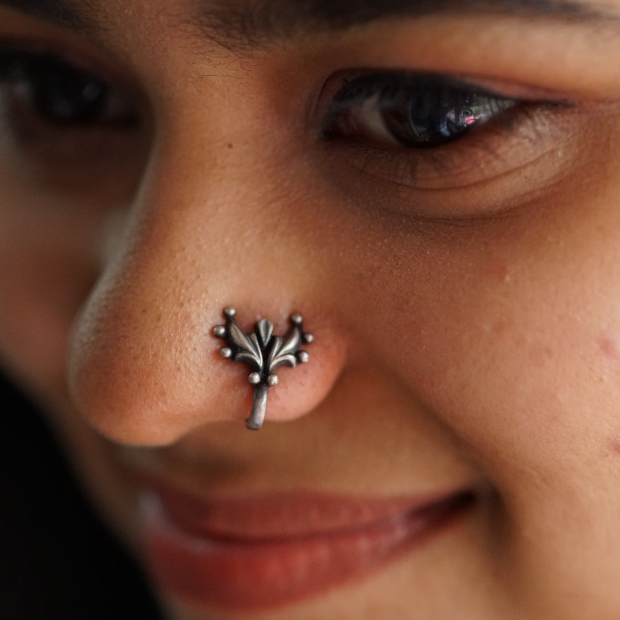 a close up of a person with a nose piercing