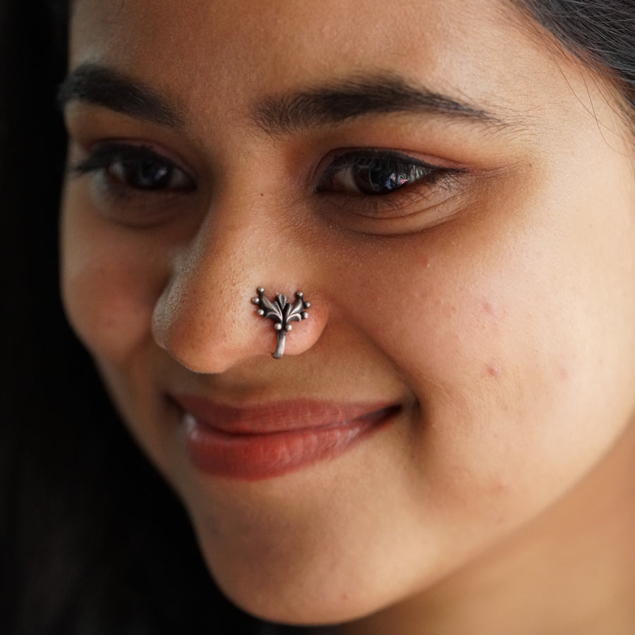 a close up of a woman with a nose piercing