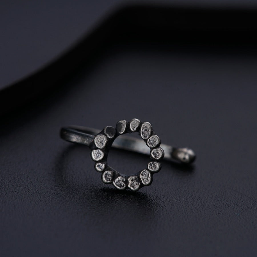 a diamond ring sitting on top of a black surface