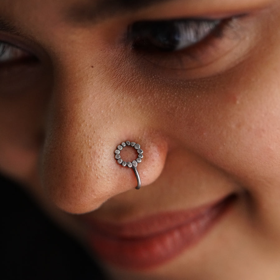 a close up of a person with a nose piercing