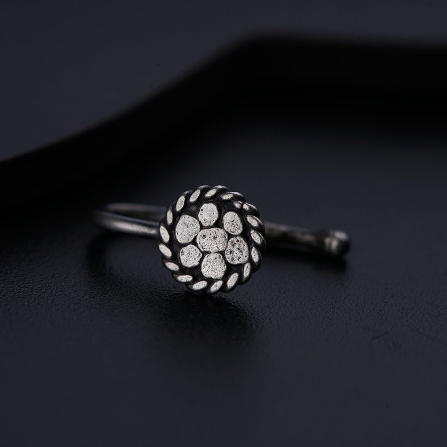 a close up of a ring on a black surface
