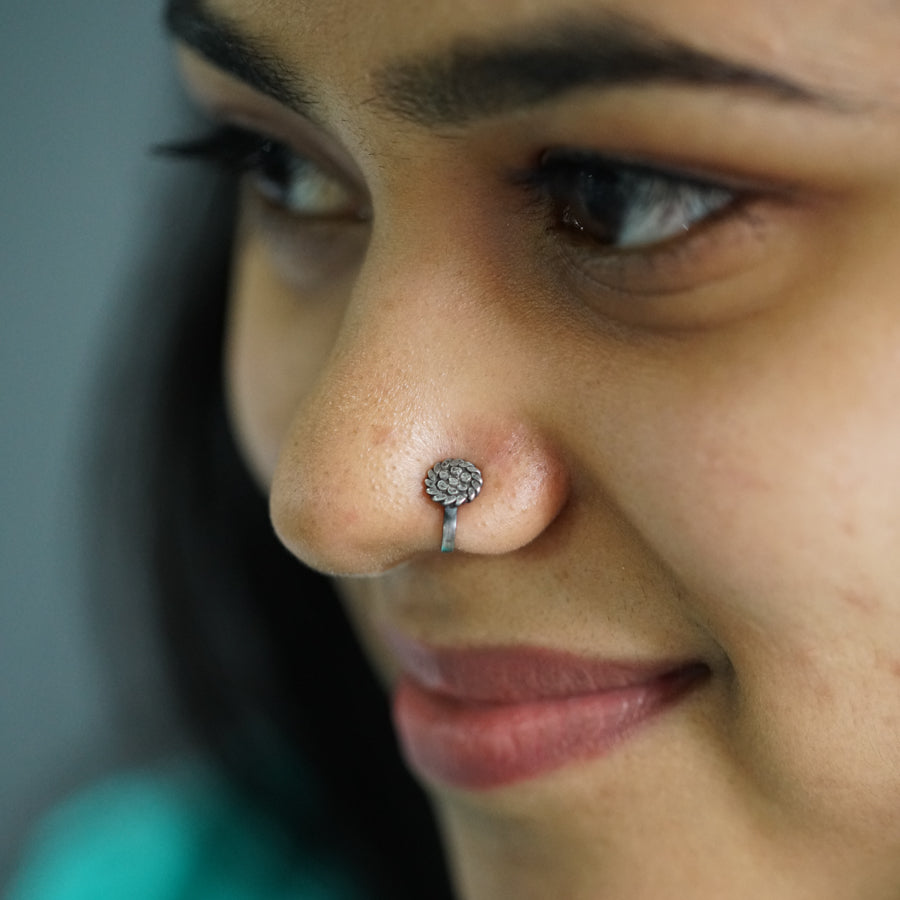 a close up of a person with a nose piercing