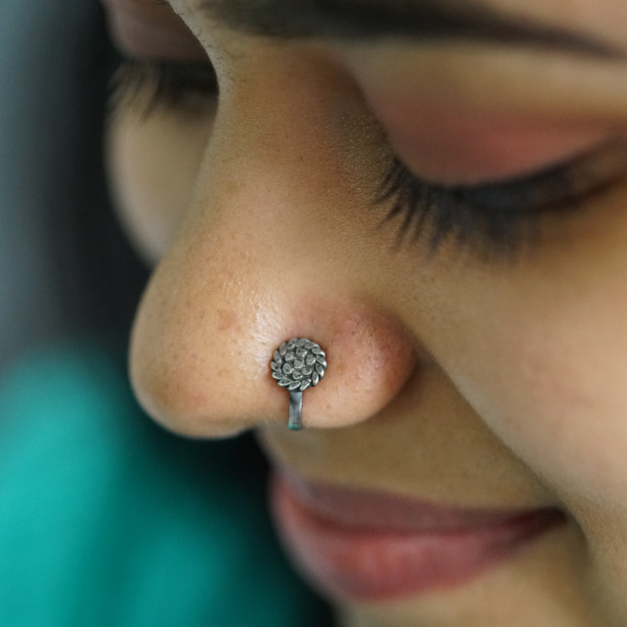 a close up of a person with a nose piercing