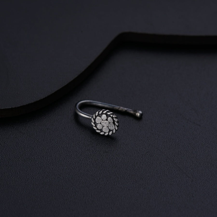 a pair of silver rings sitting on top of a black surface