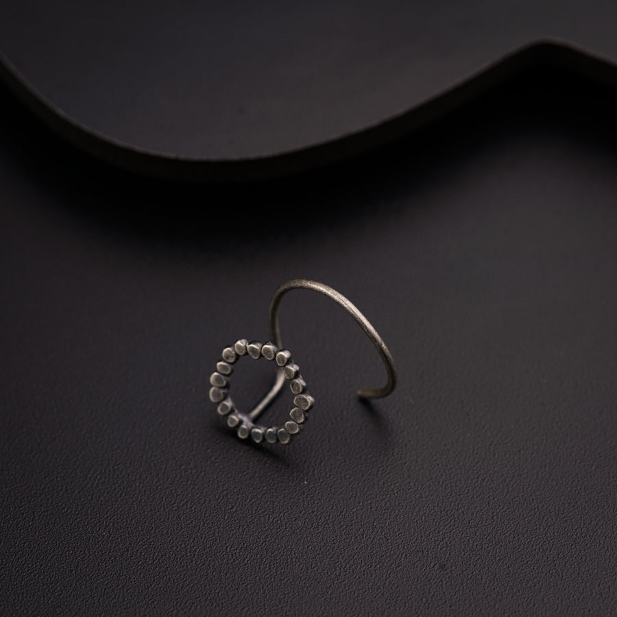 a pair of silver rings sitting on top of a table