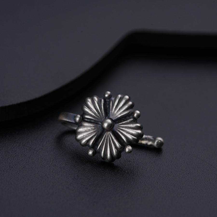 a close up of a ring on a black surface