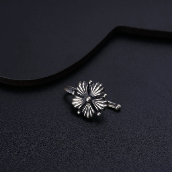 a metal object sitting on top of a black surface
