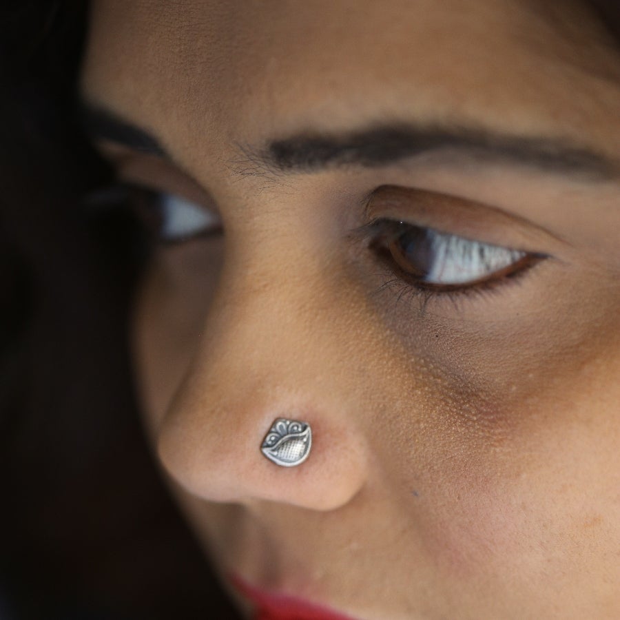 a close up of a person with a nose piercing
