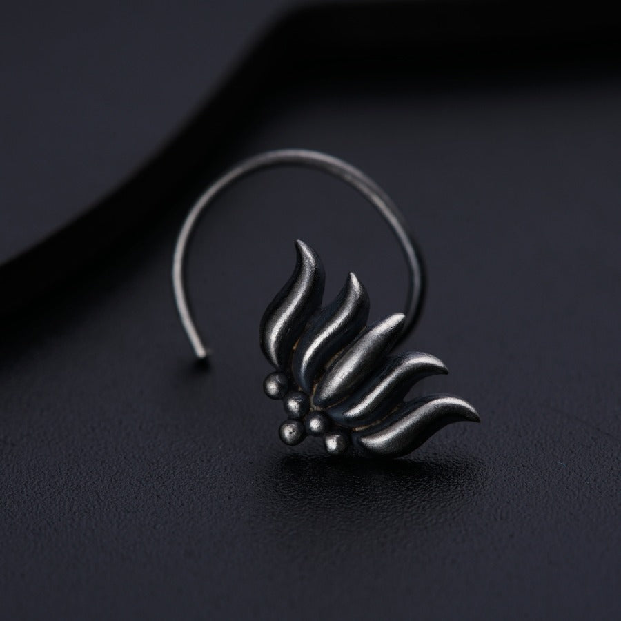 a close up of a pair of earrings on a black surface