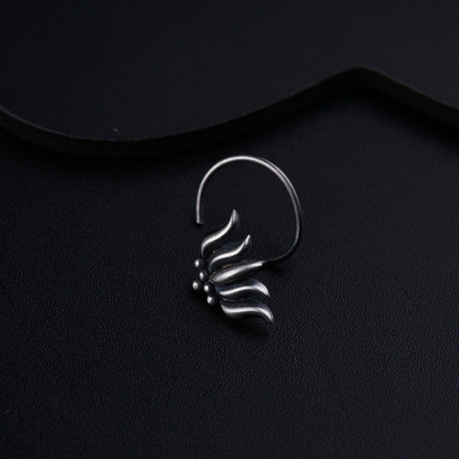 a close up of a metal object on a black surface