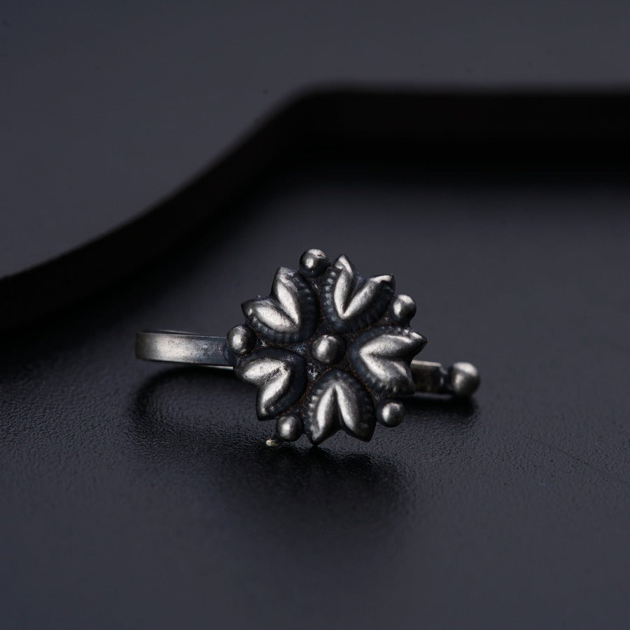 a close up of a ring on a black surface
