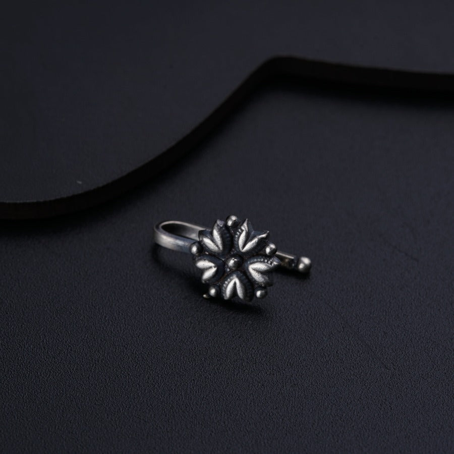 a ring sitting on top of a black surface