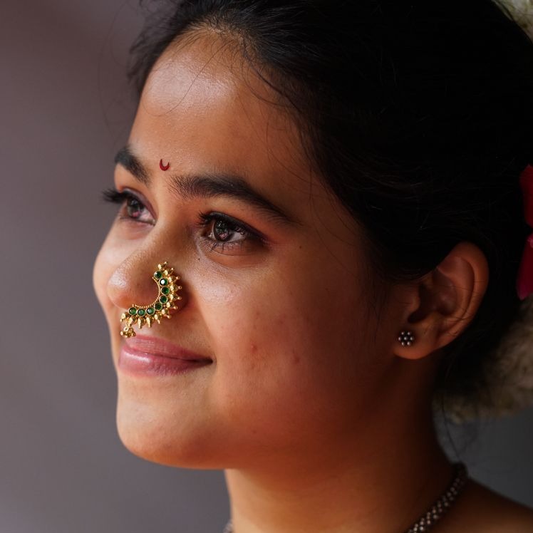 a close up of a woman with a nose ring