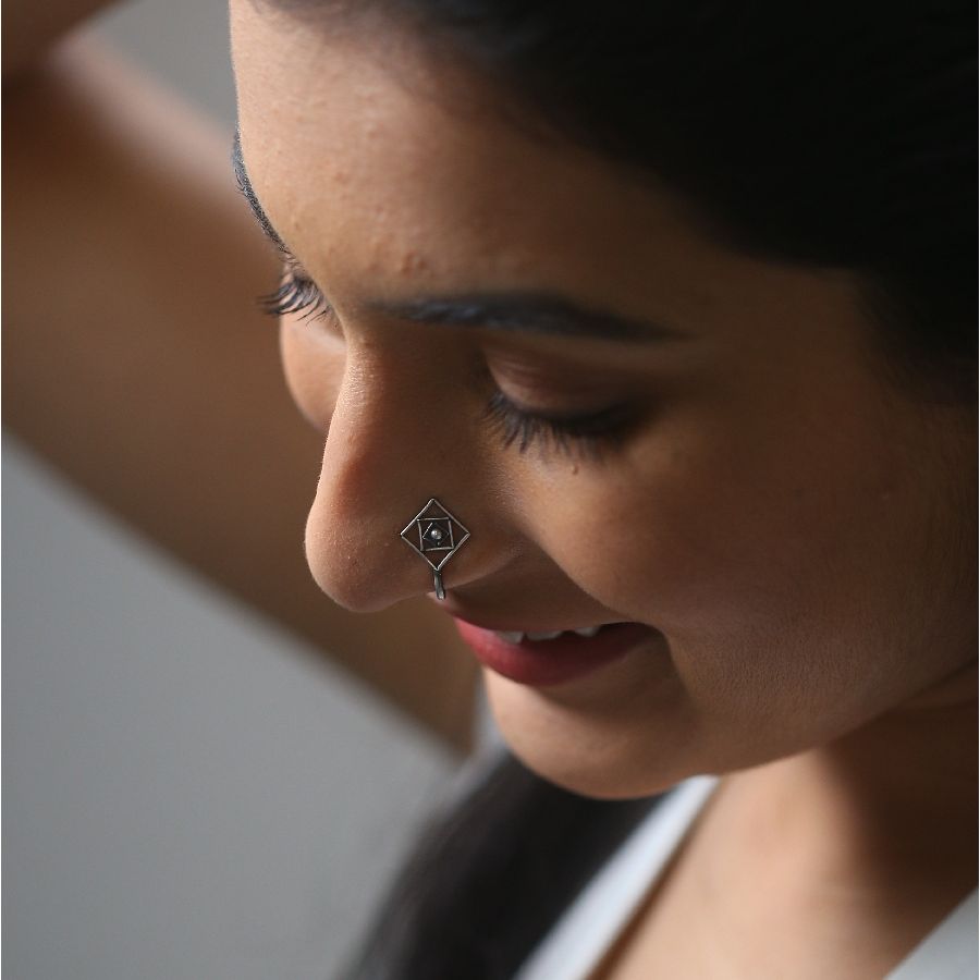 a close up of a woman with a nose piercing