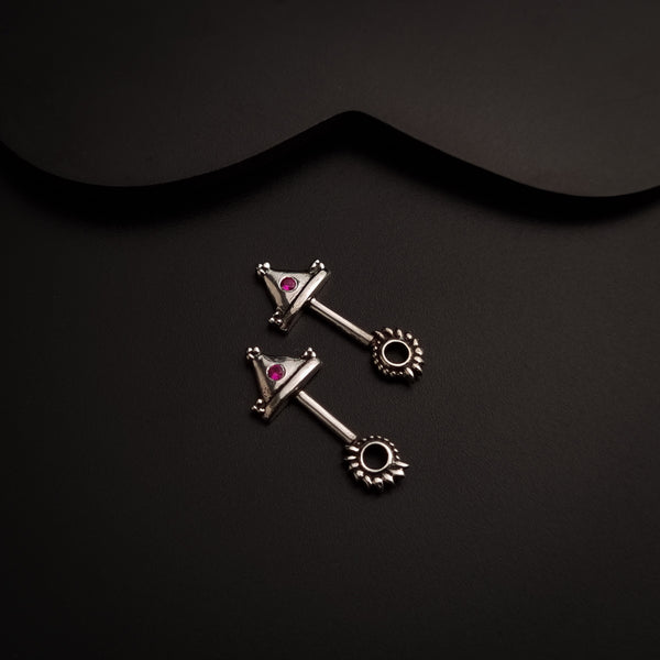 a pair of piercings on a black background