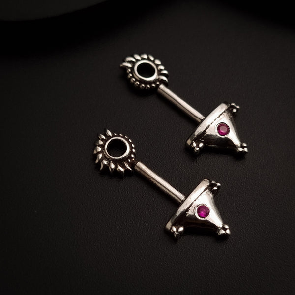 a pair of silver earrings with pink stones