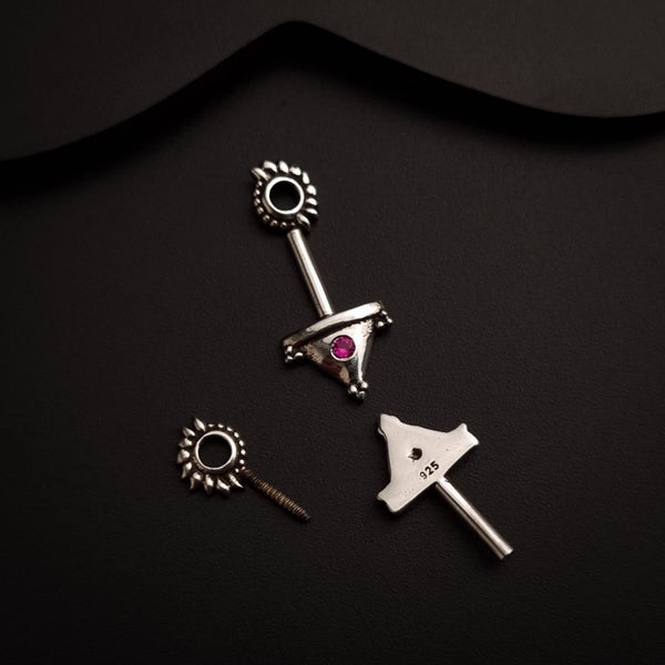 a pair of scissors and a screw on a black surface