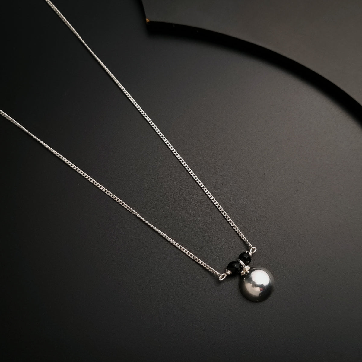 a couple of necklaces sitting on top of a table