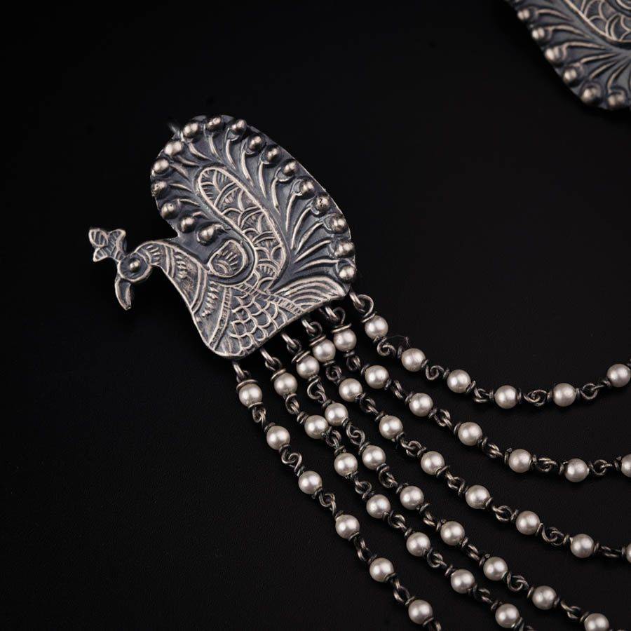 a close up of a necklace on a black surface
