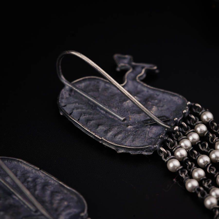 a close up of a piece of jewelry on a black surface