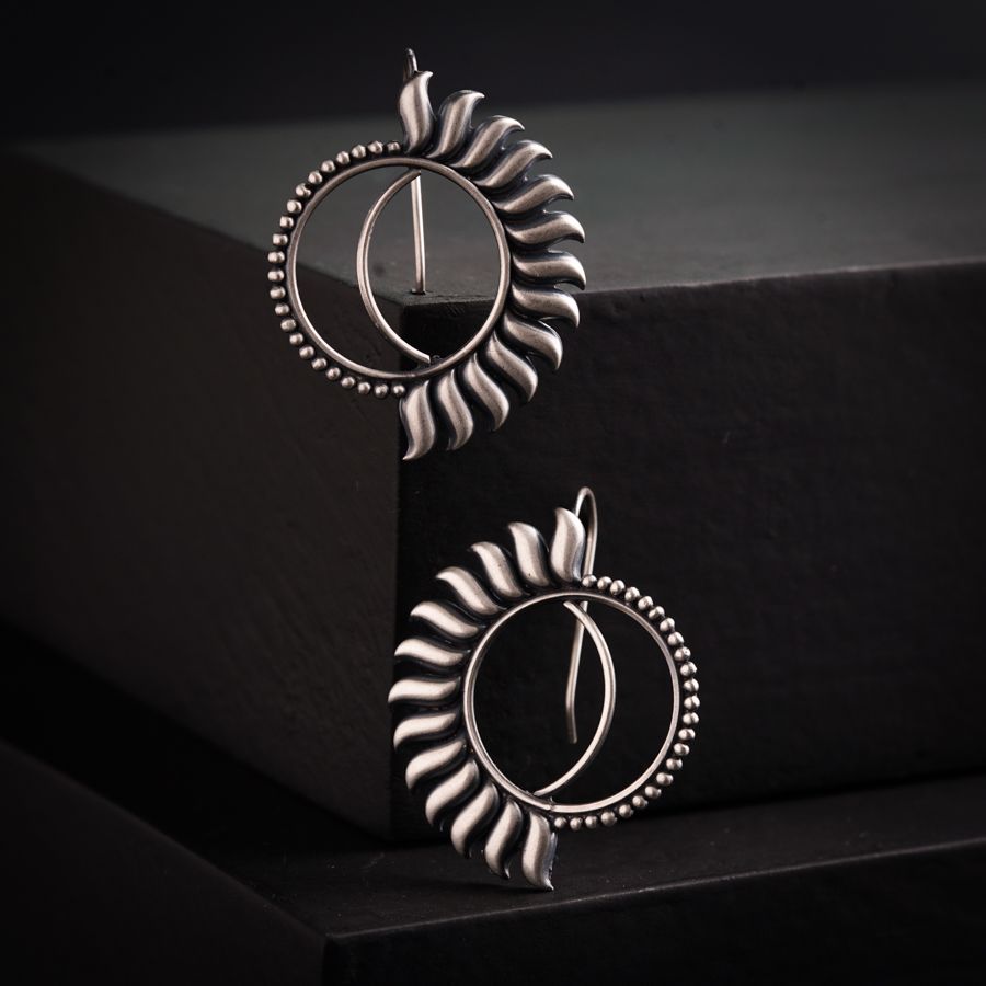 a pair of earrings sitting on top of a table