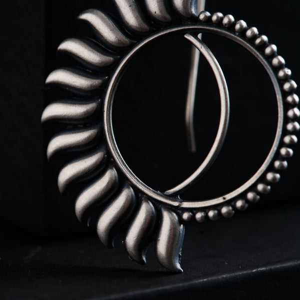 a close up of a metal object on a black surface