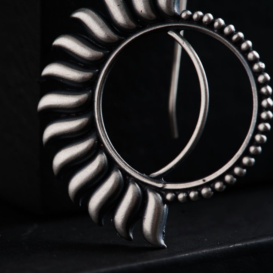 a close up of a metal object on a black surface