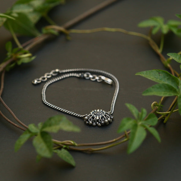 a close up of a bracelet on a table