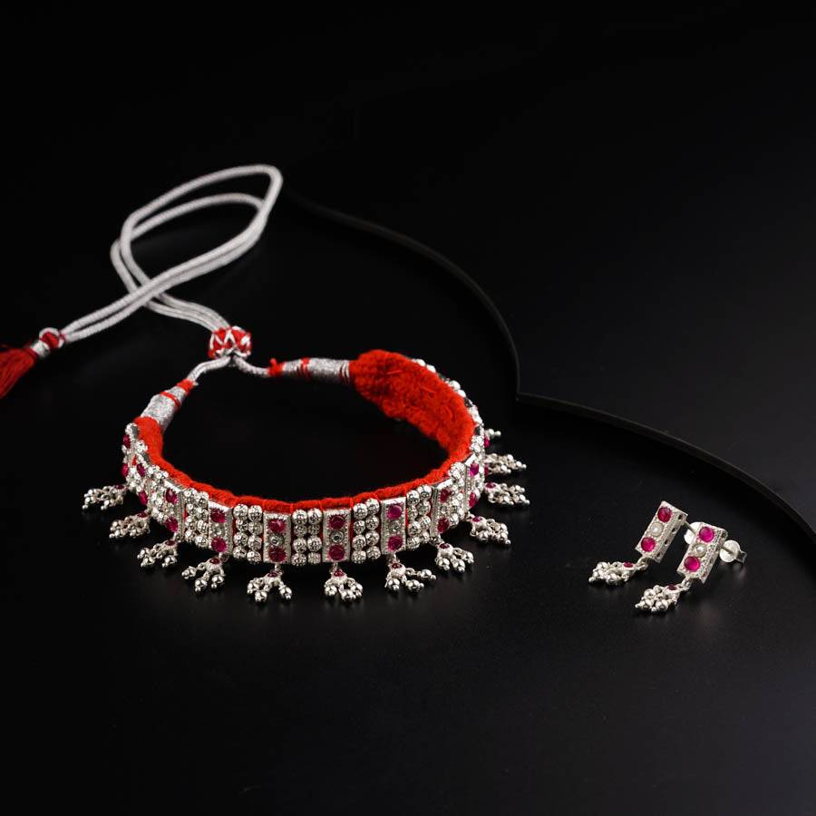 a pair of red and white bracelets on a black surface