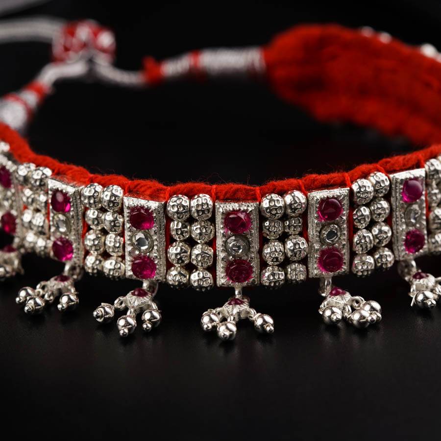 a close up of a red string bracelet