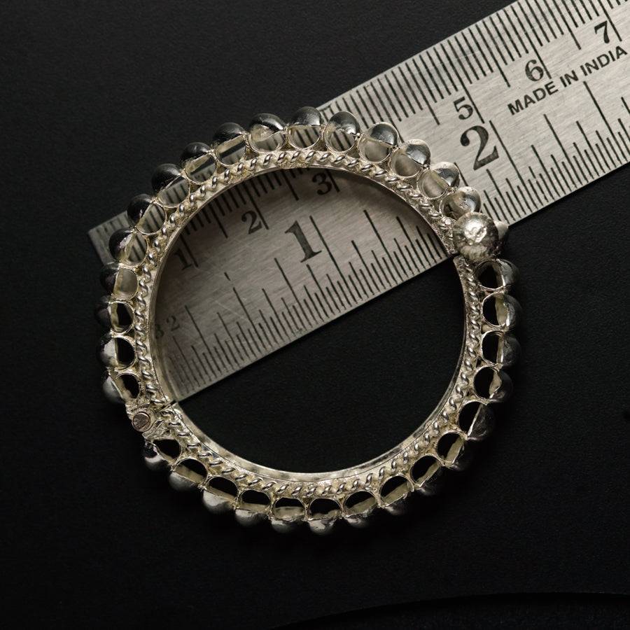 a close up of a measuring tape and a silver ring