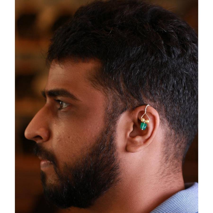 a close up of a man wearing a pair of ear piercings